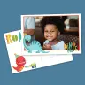 Personalised photo card featuring a smiling child, adorned with playful dinosaur illustrations in blue and red, wearing party hats. The card includes colourful text "ROAR" and "DINO MITE!" making it a fun and vibrant choice for baby shower gift ideas, children's birthday invitations, or Christmas gifts.