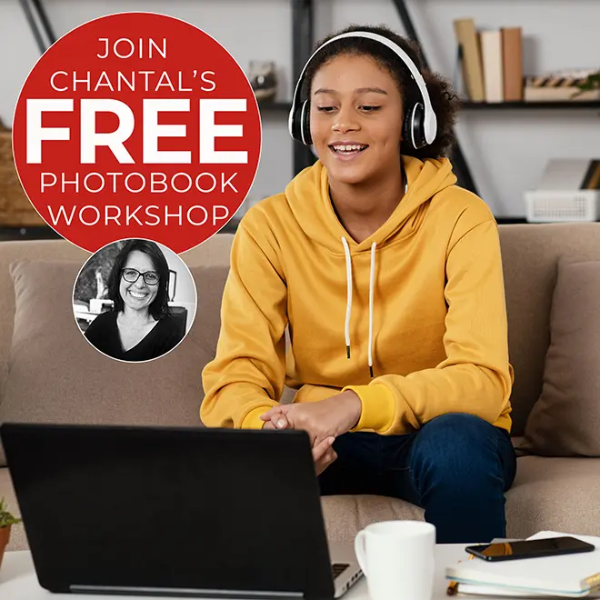 "Young woman in a yellow hoodie and headphones smiling while attending an online photobook workshop on her laptop. The image promotes 'Chantal's Free Photobook Workshop' with a circular banner featuring a photo of Chantal and text. The setting is a cosy living room with a sofa, bookshelf, and coffee table."