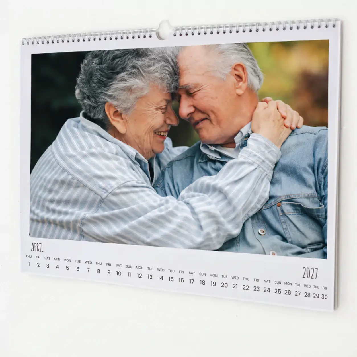 Personalised wall calendar featuring a heartwarming photo of an elderly couple embracing. The calendar is open to April 2022, with a clear monthly grid below the image. Ideal for gifts for men, Christmas gift ideas, and personalised gifts in South Africa.