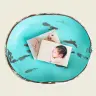 A turquoise, distressed wooden bowl containing two photo prints. One photo features a close-up of a baby's feet, and the other shows a baby with closed eyes. Ideal for personalised gifts, baby shower gift ideas, or creating a photo album book.