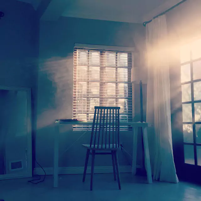 Mobile photograph by Alexander Smith, capturing sunlight streaming into a room, creating a warm and serene atmosphere