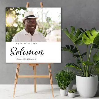 Memorial canvas print displayed on an easel at a funeral, featuring a serene image and personalised tribute, beautifully printed with RapidStudio’s canvas printing specials.