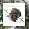 "Square photo book cover titled 'Celebrating the life of Mandisa Zondi' featuring a circular photo of an elderly woman with glasses, surrounded by botanical elements and white flowers. The background includes green leaves, creating a serene and natural theme. Ideal for memorial keepsakes."