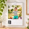 Personalised wall calendar for April 2023 featuring a colourful image of a smiling child in a pool float. The calendar has a clean, minimalist design with dates clearly marked. Ideal for gifts such as baby shower gift ideas, Christmas gifts, or personalised gifts in South Africa.