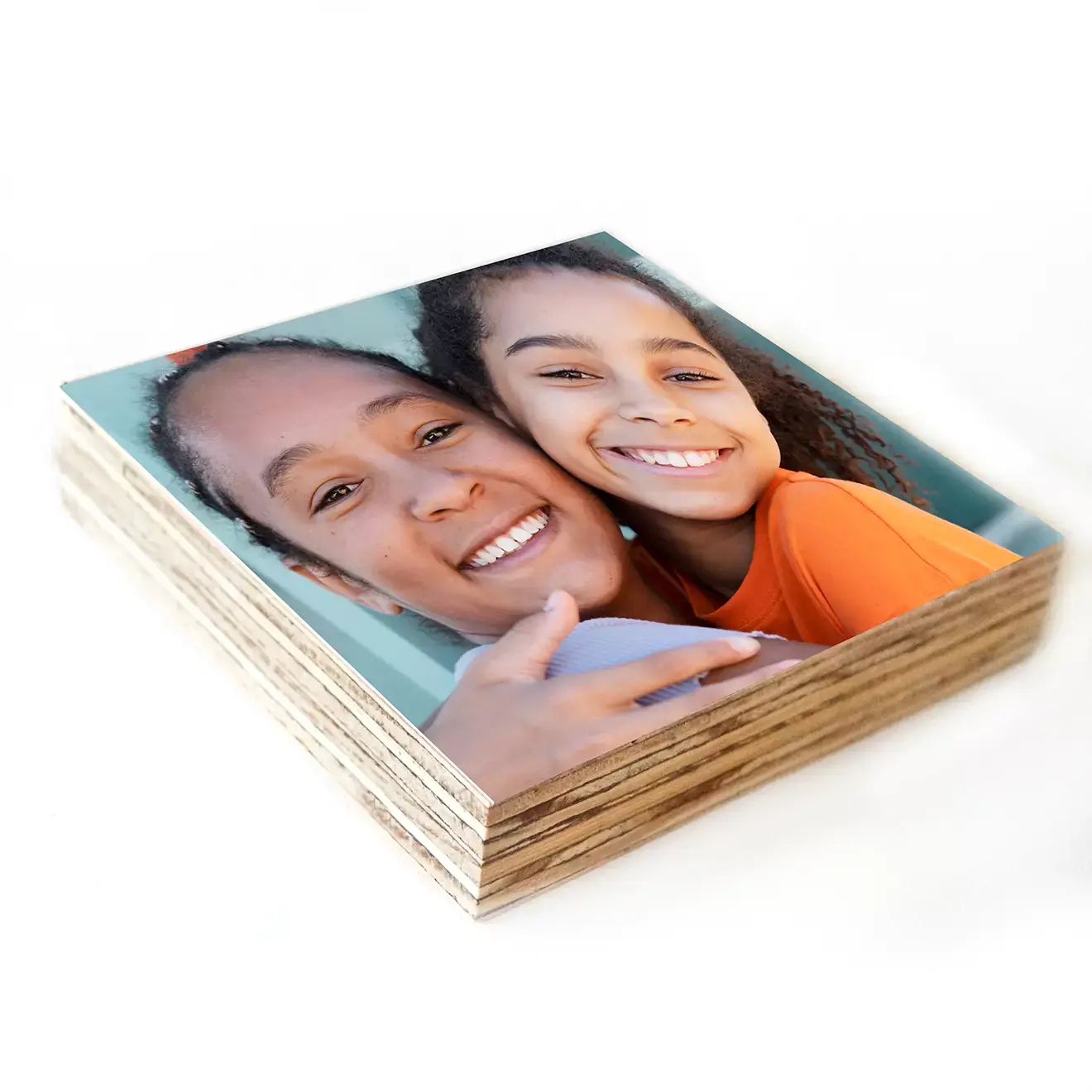 Stack of personalised photo books featuring a cover image of a smiling woman and child. The photo books have a square format and appear to be printed on high-quality paper. Ideal for gifts such as baby showers, Christmas, or Valentine's Day, and perfect for preserving cherished memories.