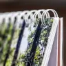 Close-up image of a spiral-bound photo book with high-quality printed pages. The book features a sturdy white wire binding and glossy pages showcasing vibrant, detailed photographs. Ideal for personalised gifts, photo albums, and special occasions such as Christmas or Valentine's Day.