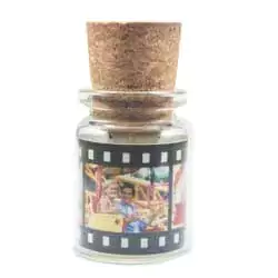 A unique USB flash drive designed to look like a small glass bottle with a cork stopper. The bottle features a decorative film strip with colourful images wrapped around its exterior. Ideal as a personalised gift, it combines functionality with a creative, vintage-inspired design. Suitable for various occasions such as birthdays, Christmas, or Valentine's Day.