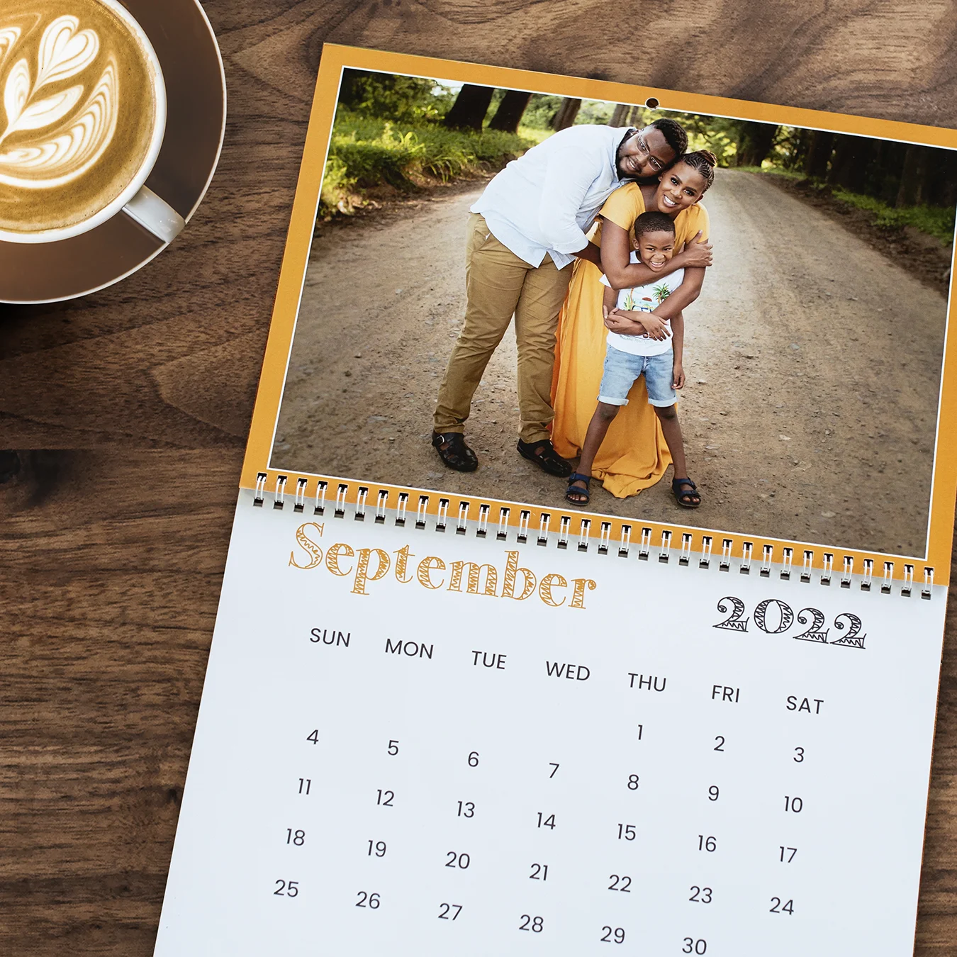 Personalised wall calendar featuring a warm family portrait for each month, highlighted with phrases in multiple South African languages, celebrating family bonds and cultural diversity.