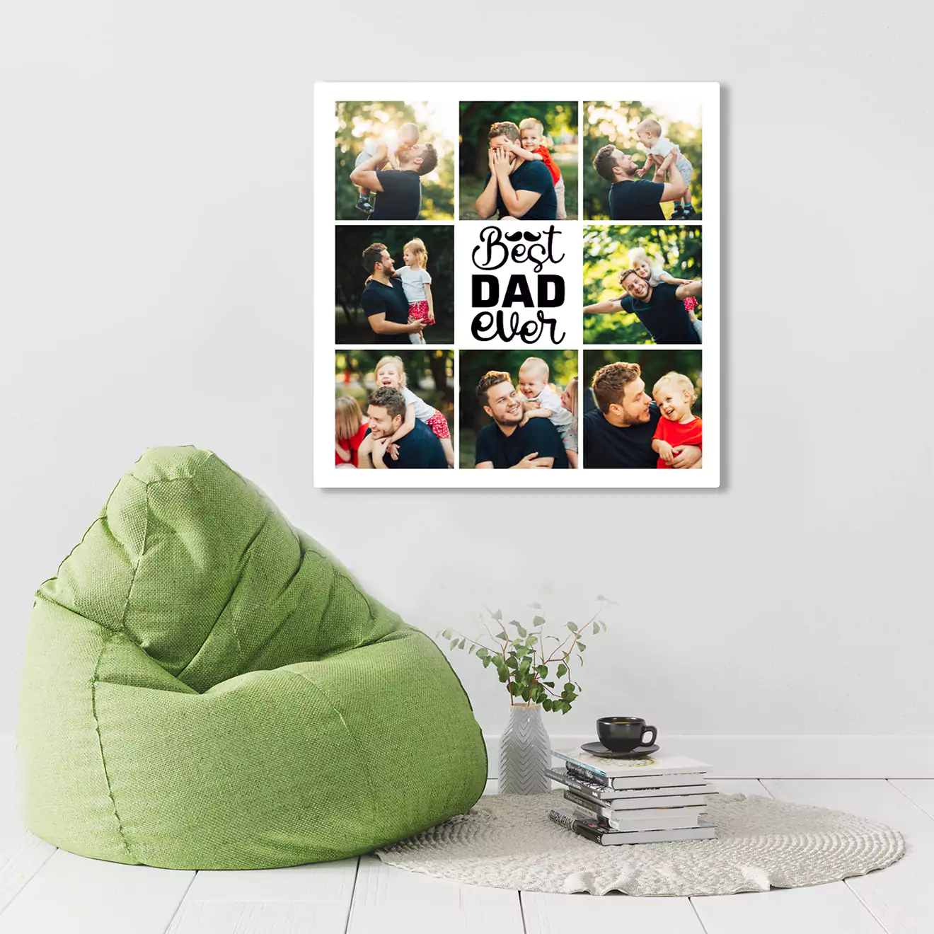 A collage photo frame with the words 'Best Dad Ever' in the center, surrounded by various pictures of a father and child. The frame is displayed on a white wall above a green bean bag chair and a small table with a plant and books.