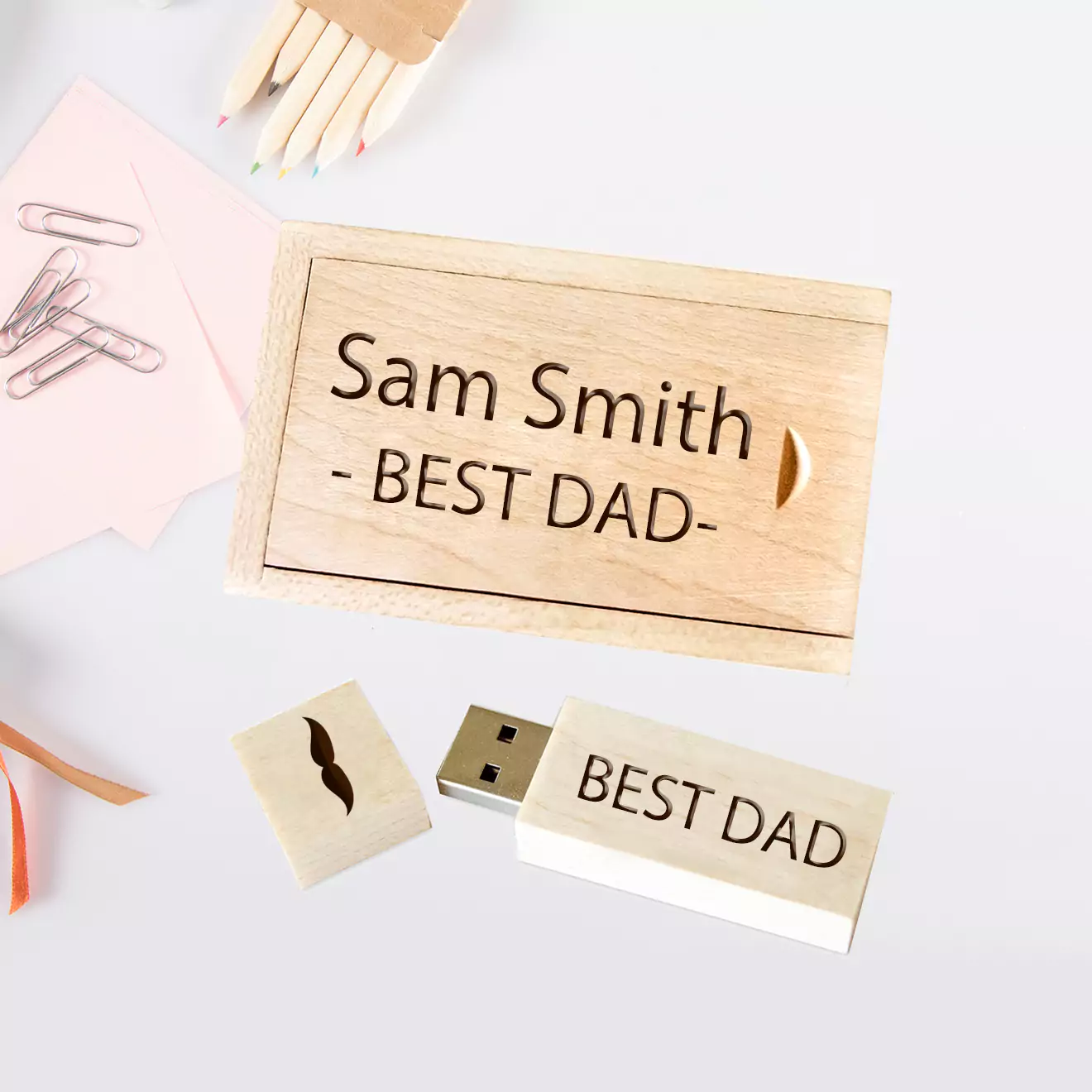 Four flash drives, each presented in a custom box, showcasing detailed laser engraving on the casings, ideal for personalised gifts or professional use.