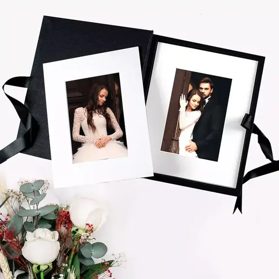 Complete folio print box set displaying 5-18 beautifully mounted photos on matte board frames, showcasing the entire product with its elegant packaging and choice of three frame colours.