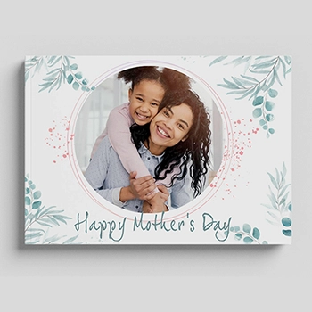 Mother's Day photobook cover featuring a smiling mother and daughter in a circular frame, surrounded by floral and leafy designs with the text 'Happy Mother's Day' at the bottom.