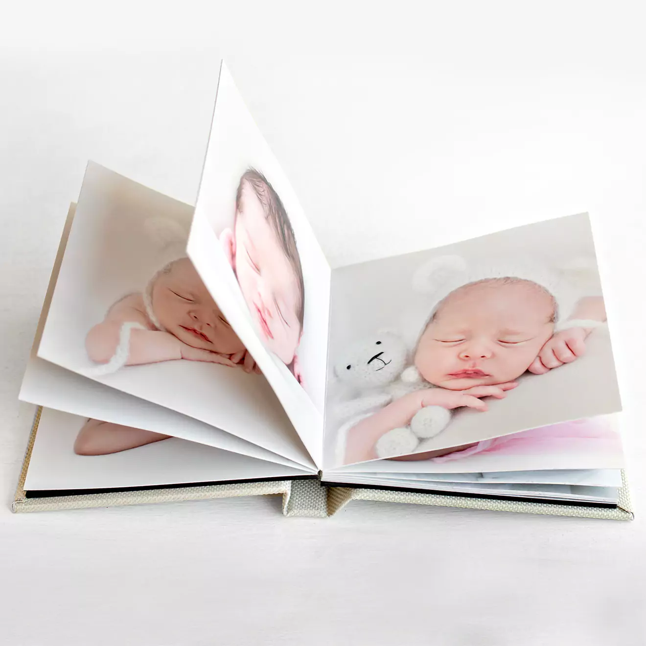 Open personalised baby photo book displaying images of a sleeping baby, ideal for capturing and preserving precious newborn memories. Perfect for baby gifts and keepsakes.