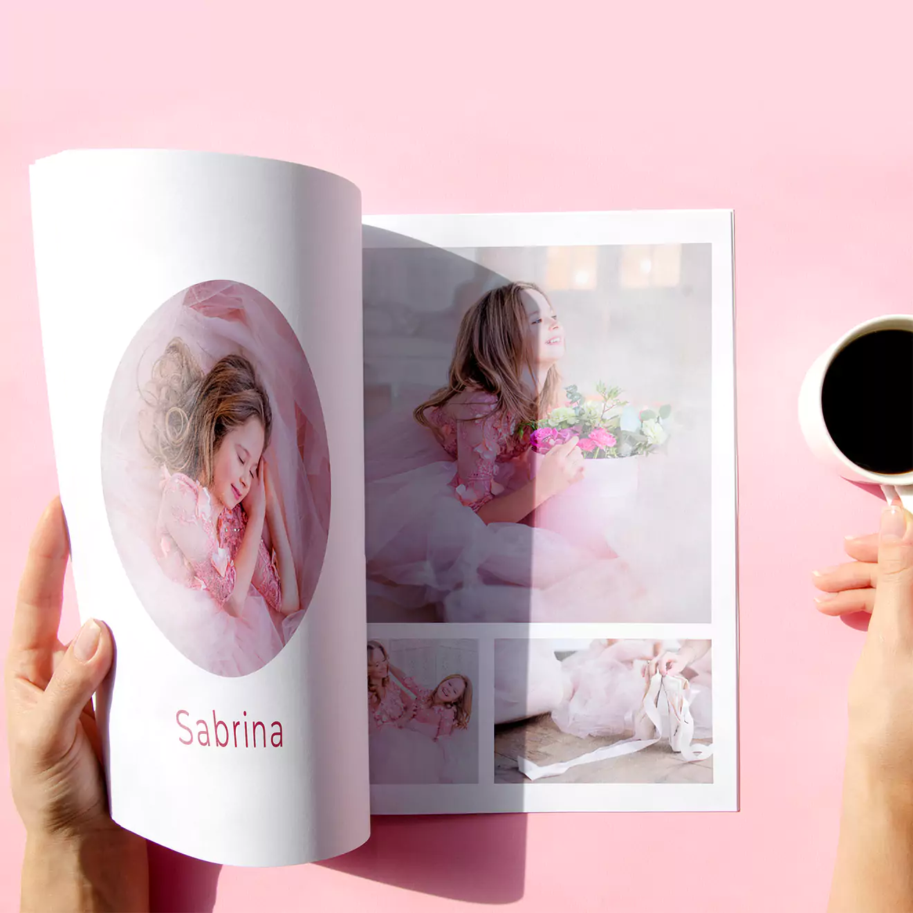 Person holding a photobook with images of a young girl in pink attire, labeled 'Sabrina,' while holding a cup of coffee against a pink background.