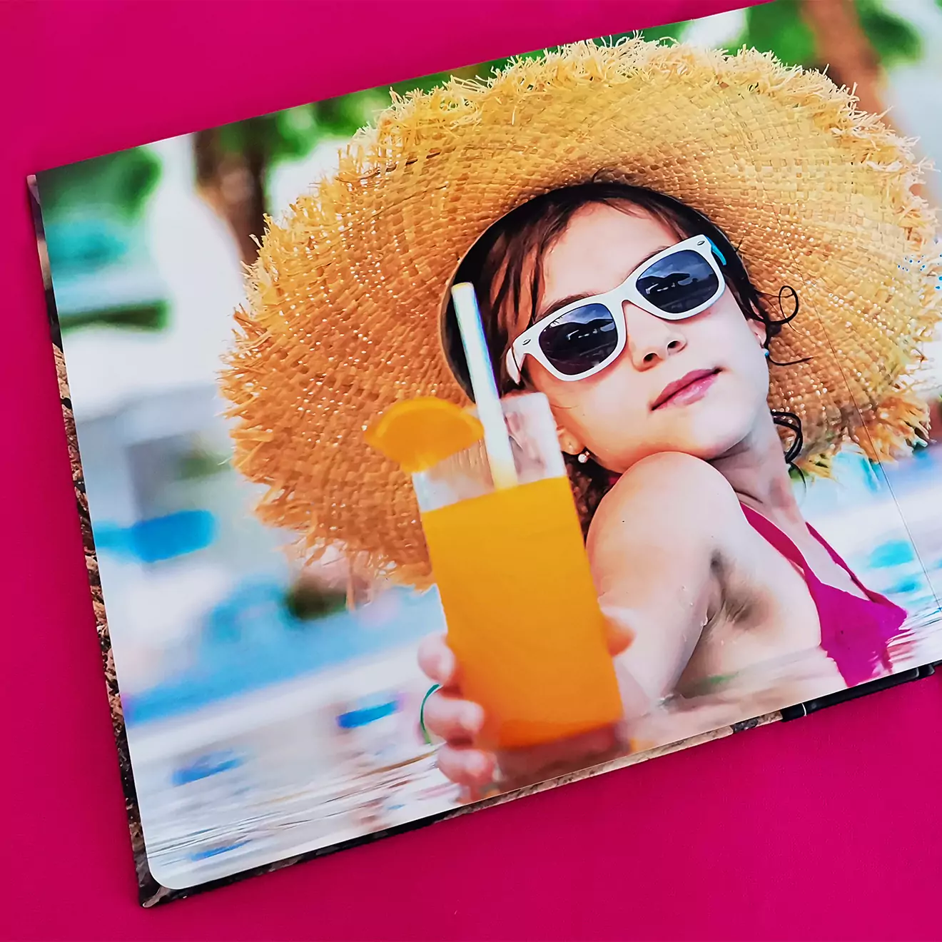 A collection of photographic prints featuring beach scenes and people enjoying sunny weather, displayed on a wooden surface. The prints showcase vibrant colors and clear, high-quality images.