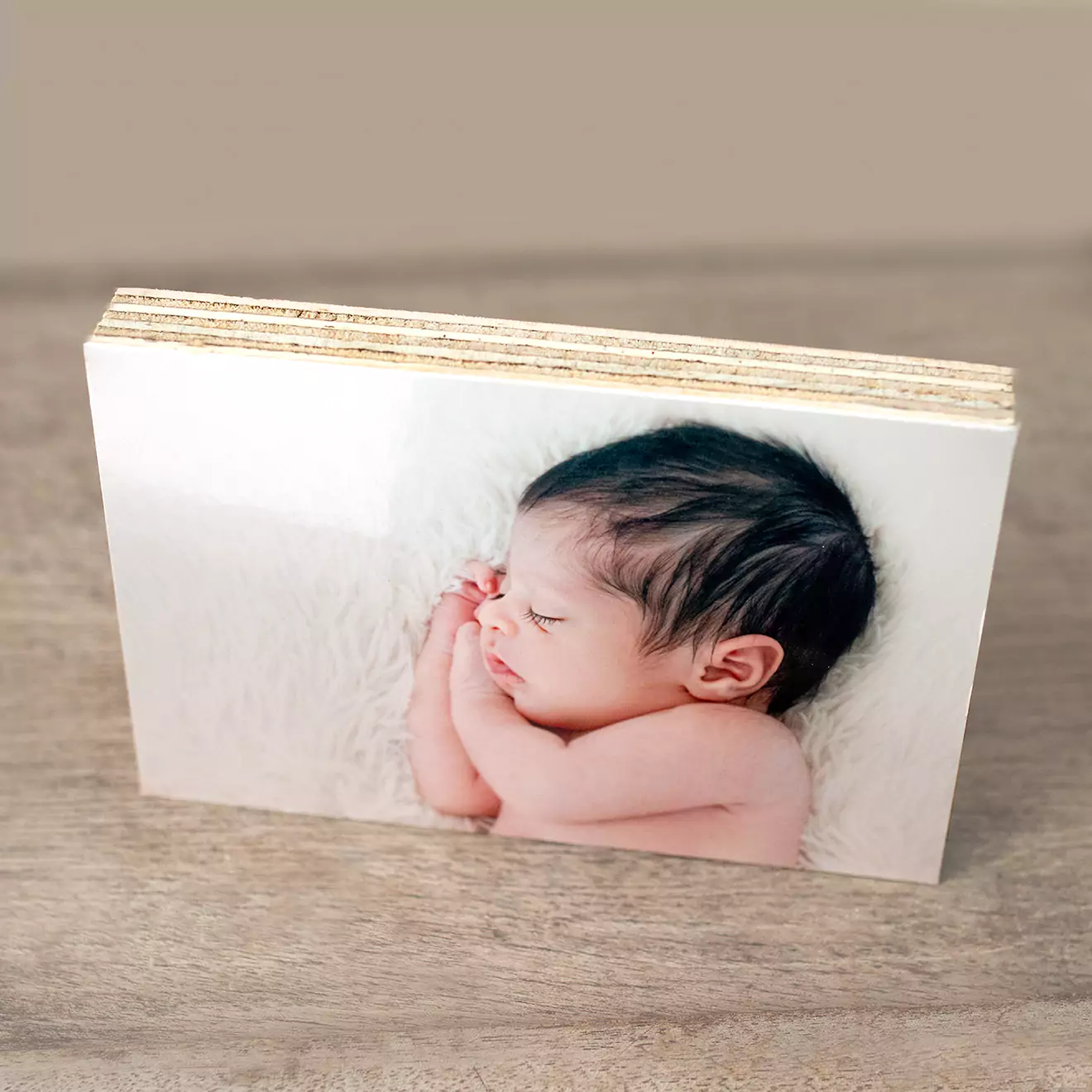 Personalised shutterblocks displaying a tender moment with a newborn, capturing the serene beauty and delicate details of new life, ideal for cherishing the beginning of a family's journey.