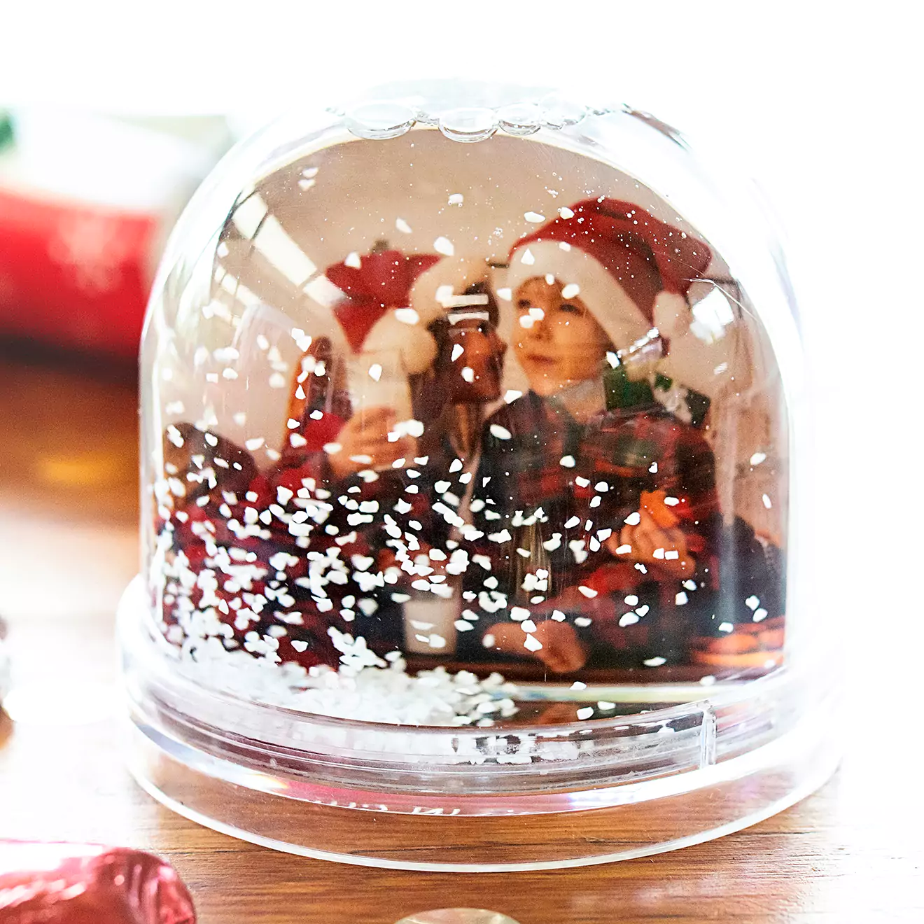 Personalised snow globe featuring two kids dressed in festive Christmas outfits, with snow gently falling around them, capturing the spirit and joy of the holiday season.