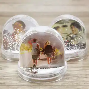 Set of three snow globes, each containing different images ranging from family portraits to scenic views, beautifully capturing a variety of cherished memories amidst falling snow.