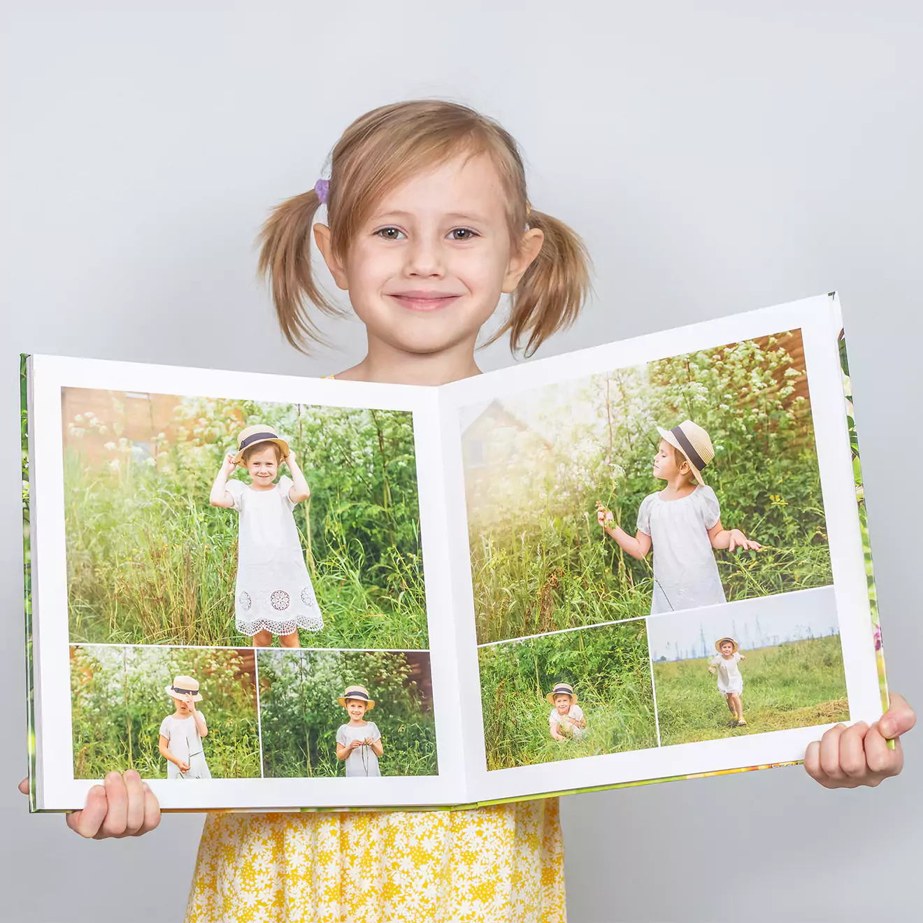 A young girl in a yellow dress holds open a large photo album featuring vibrant outdoor photos of herself. Ideal for personalised gifts, photo books, and special occasions like Christmas or baby showers.