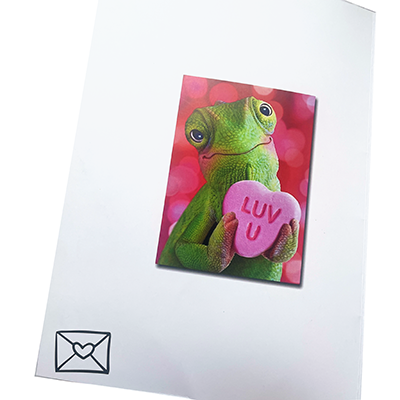 Valentine's Day card featuring a cute green lizard holding a pink heart-shaped candy with the text 'LUV U' on a pink background. The card has a small envelope icon in the bottom left corner.