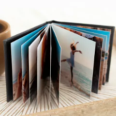 Open Instabook showcasing vibrant, high-quality printed photos, ideal for preserving memories. The compact, stylish photo album features a black cover and thick pages, perfect for personalised gifts in South Africa, baby shower gift ideas, or Christmas gifts.