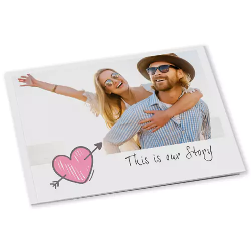 Softcover mini photobook featuring a couple smiling and embracing on the cover. The design includes a pink heart with an arrow and the text "This is our Story." Ideal for personalised gifts in South Africa, photo albums, and special occasions like Valentine's Day, Christmas, or birthdays.