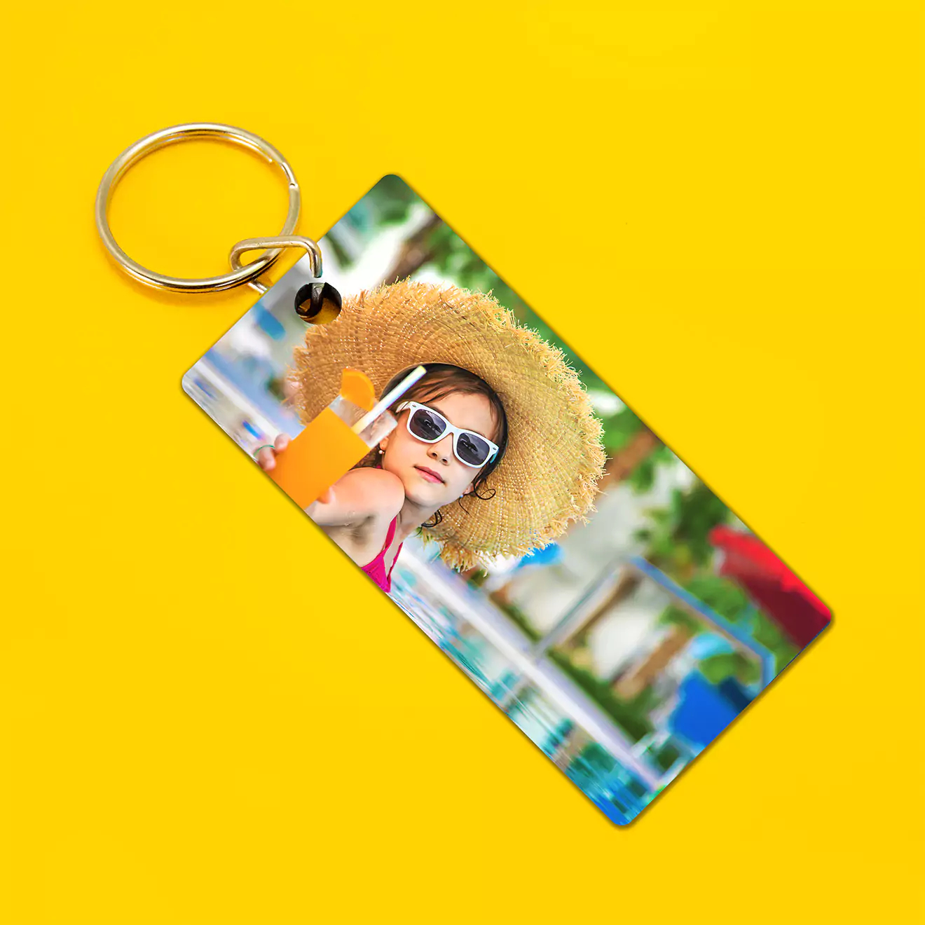 Personalised thin rectangular keyring featuring a vibrant photo of a child wearing sunglasses and a straw hat, set against a bright yellow background. Ideal for gifts for men, women, and special occasions.