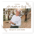 Personalised funeral photo book cover featuring a man in a white shirt and hat, with the text 'In loving memory' and 'Benjamin John Bailie.' The design includes delicate floral accents, making it a thoughtful memorial gift. Ideal for commemorating loved ones.