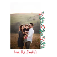 Christmas-themed greeting card featuring a family photo with a festive design of green leaves and red berries along the right edge. The card includes the text 'Love the Smith's' in red cursive at the bottom. Ideal for personalised Christmas gifts and holiday greetings.