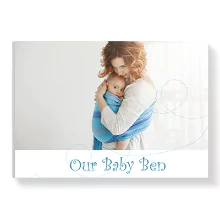 Hardcover baby photo book in baby blue theme featuring a mother holding her baby on the cover. The text 'Our Baby Ben' is written in elegant blue font. Ideal for baby shower gift ideas, personalised gifts in South Africa, and photo albums to cherish precious moments.