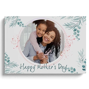 Hardcover photo book with a 'Happy Mother's Day' theme, featuring a circular photo of a smiling mother and child on the cover. The design includes green leafy accents and a light, elegant background. Ideal for personalised gifts in South Africa, perfect for Mother's Day or other special occasions.