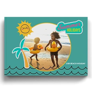 Summer-themed hardcover photo book featuring a vibrant beach holiday design. The cover showcases two children playing on the beach with inflatable duck rings, set against a turquoise background with playful illustrations of a sun, palm tree, and waves. Ideal for personalised gifts, photo albums, and holiday memories.