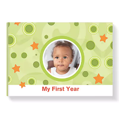 Hardcover photo book with a 'My First Year' theme, featuring a green background with orange stars and green circles. The cover includes a circular photo of a baby in the centre. Ideal for baby shower gift ideas, personalised gifts in South Africa, and photo albums.