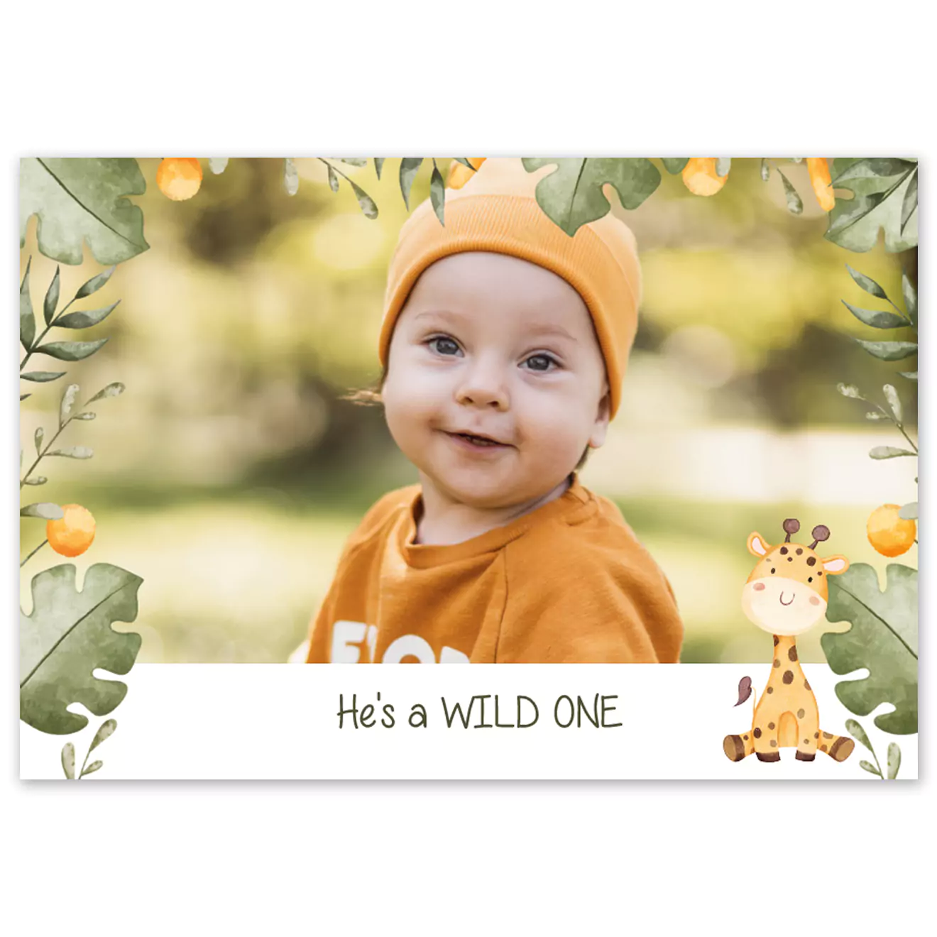 Photobook cover featuring a baby in an orange outfit with the text ‘He’s a WILD ONE,’ surrounded by cute lion and elephant illustrations.