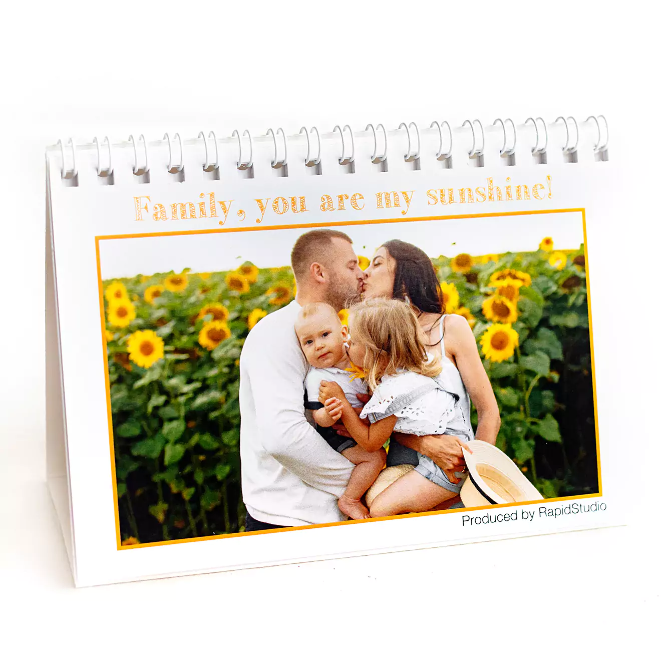 Personalised desk photo calendar featuring a family photo with sunflowers in the background. Spiral-bound with a white base, perfect for gifts for her, Christmas gifts, or baby shower gift ideas.