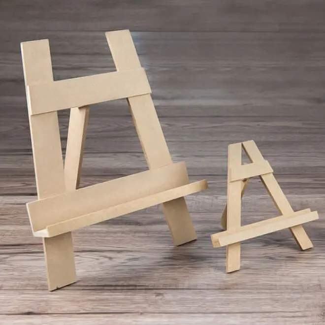 Two wooden easels of different sizes placed on a wooden surface. The larger easel is on the left, and the smaller one is on the right. Both easels are made of light-coloured wood and have a simple, minimalist design. Ideal for displaying photo books, albums, or canvases.