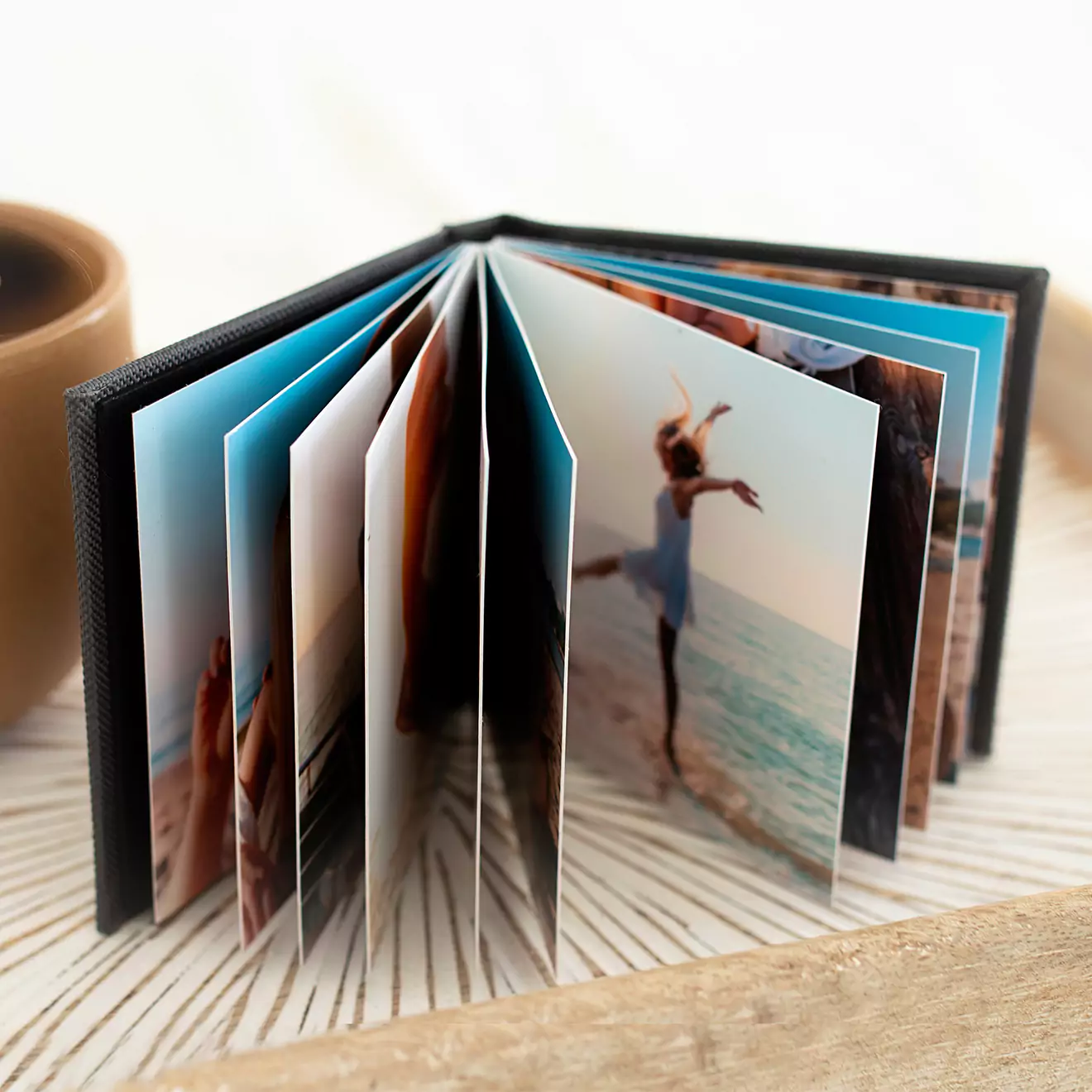 Image of a tiny personalised photobook from RapidStudio, known as a bragbook, perfect for carrying and showcasing cherished photos in a portable format.