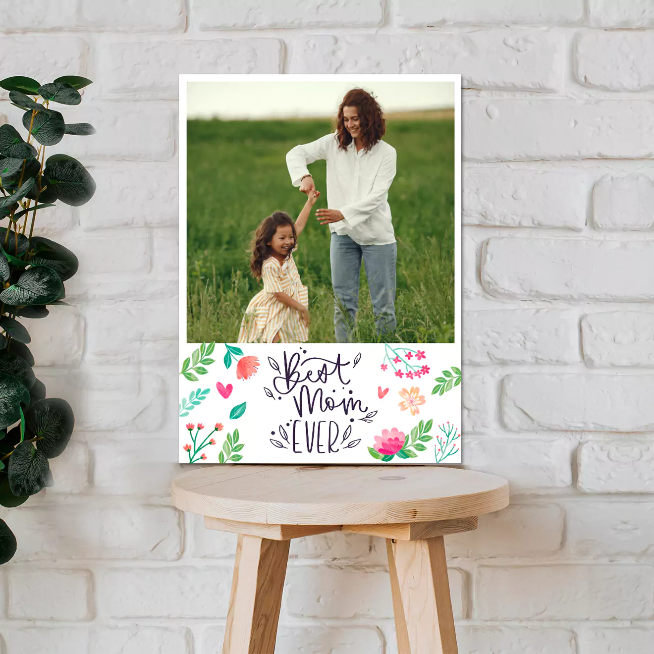 Hands holding a personalised photo canvas featuring a couple sitting closely together, with a festive background adorned with red ribbons and candles. Ideal for gifts for men, Christmas gift ideas, Valentine's Day gift ideas, and personalised gifts in South Africa.