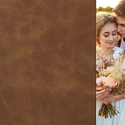 Photobook or album cover with a brown leather texture on the left side and a romantic photo of a couple holding a bouquet of flowers on the right side. The couple is outdoors, sharing an intimate moment.