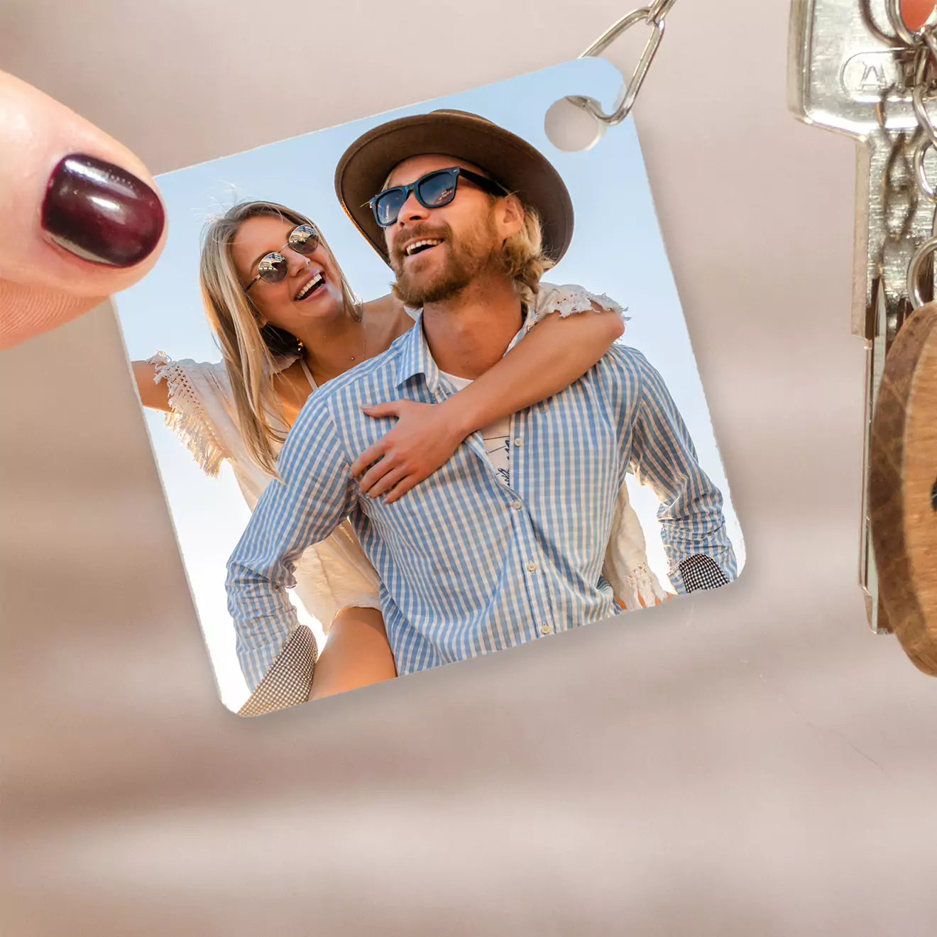 Square personalised keyring featuring a photo of a smiling couple, with the woman piggybacking on the man. The keyring is attached to a set of keys. Ideal for gifts for men, gifts for her, or Valentine's Day gift ideas. Perfect as a personalised gift in South Africa.