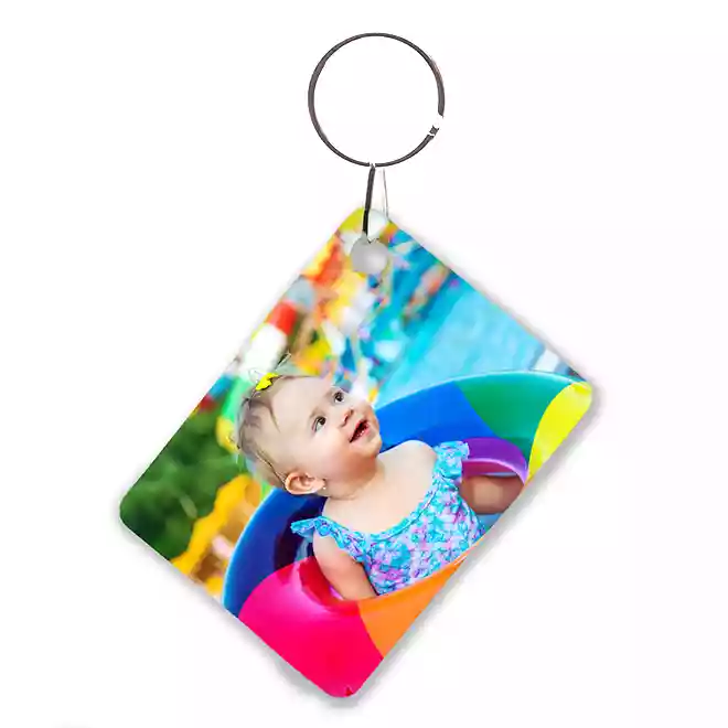 Personalised keyring featuring a colourful photo of a smiling baby in a swimming pool float. The keyring has a rectangular shape with a metal ring for easy attachment. Ideal as a baby shower gift, Christmas gift, or a thoughtful keepsake for parents.