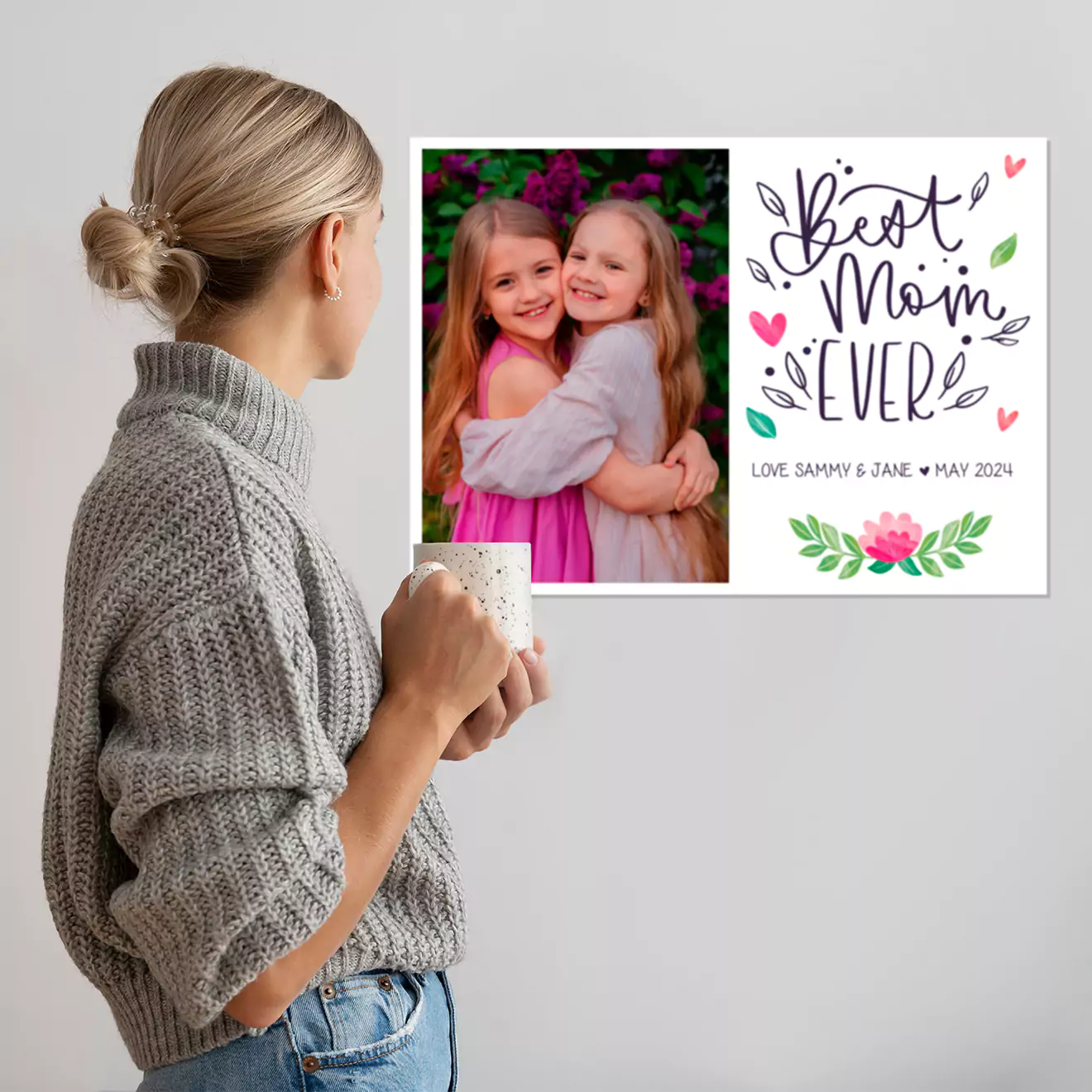 A proud mum admiring a themed canvas collage on the wall, perfect for Mother's Day. This personalised gift is an ideal way to celebrate cherished memories, making it a thoughtful present for her in South Africa.