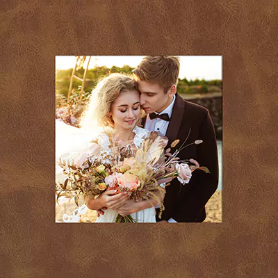 Monoblock photobook or album cover bound with genuine leather, vegan leather, canvas or linen which provides a beautiful square frame to a hero image on the front cover.
