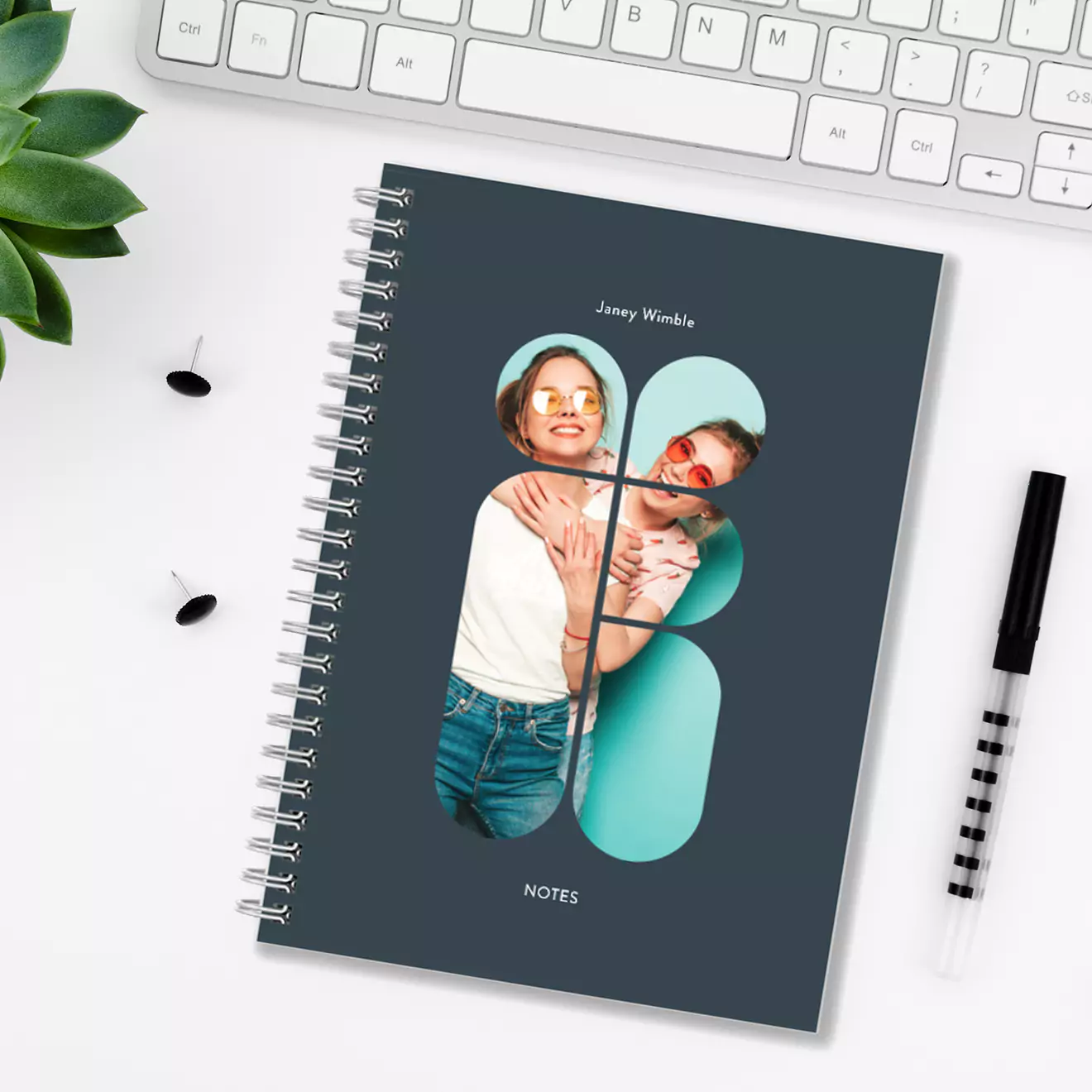 Personalised spiral-bound notebook with a custom photo cover featuring a couple, placed on a white desk with a keyboard, pen, and plant. Ideal for gifts for men, baby shower gift ideas, Christmas gifts, and personalised gifts in South Africa. Stylish and practical for everyday use.