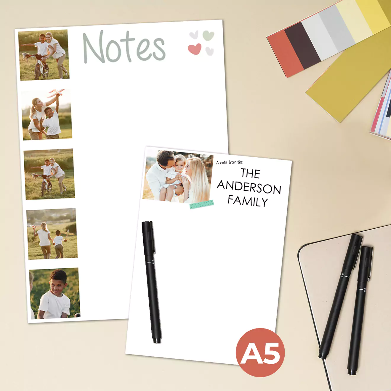 "A5-sized personalised notepads featuring family photos and custom text. One notepad has a 'Notes' header with a column of family photos on the left side, while the other displays a family photo with 'The Anderson Family' text. Ideal for gifts, including Christmas and baby showers."