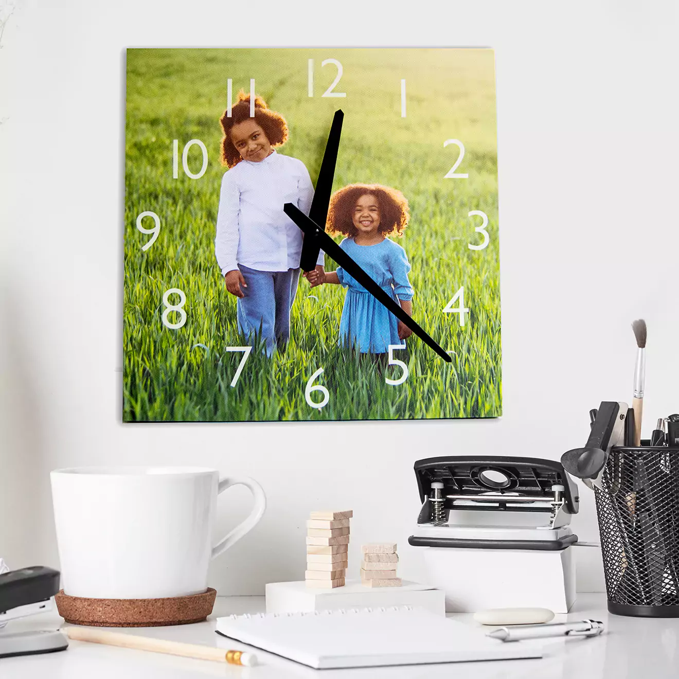 30cm square Canvas Clock with Funky Faces, personalised with your chosen pictures as the backdrop, surrounded by an array of vibrant and quirky clock face designs. This unique piece combines practicality with personal flair, making it a standout addition to any room looking for a touch of whimsy and a lot of character.