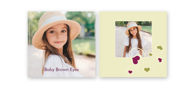 Personalised photo book with a ''Love Tree'' theme cover. The cover features a young girl wearing a straw hat, with the text ''Baby Brown Eyes''. The inside page has a photo of the same girl surrounded by heart illustrations. Ideal for gifts, baby showers, and personalised keepsakes.