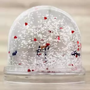 Personalised heart-filled snow globe with a child's picture, symbolising love and joy amidst a flurry of hearts, perfect for festive and romantic holiday decor.