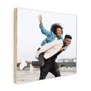 Square photobook with a custom cover featuring a joyful couple. The woman is playfully riding on the man's back, both smiling and enjoying an outdoor moment. Perfect for preserving cherished memories.