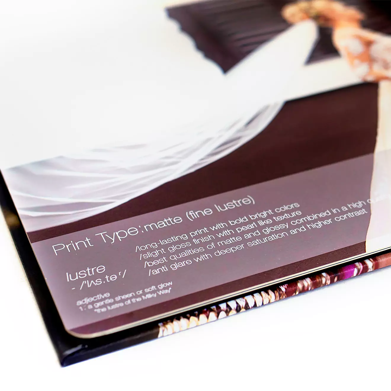 Close-up of a high-quality photobook with a matte (fine lustre) print type, showcasing vibrant and detailed images. The photobook features a sleek, glossy cover with a spiral binding, making it an ideal personalised gift for various occasions such as weddings, birthdays, or anniversaries.